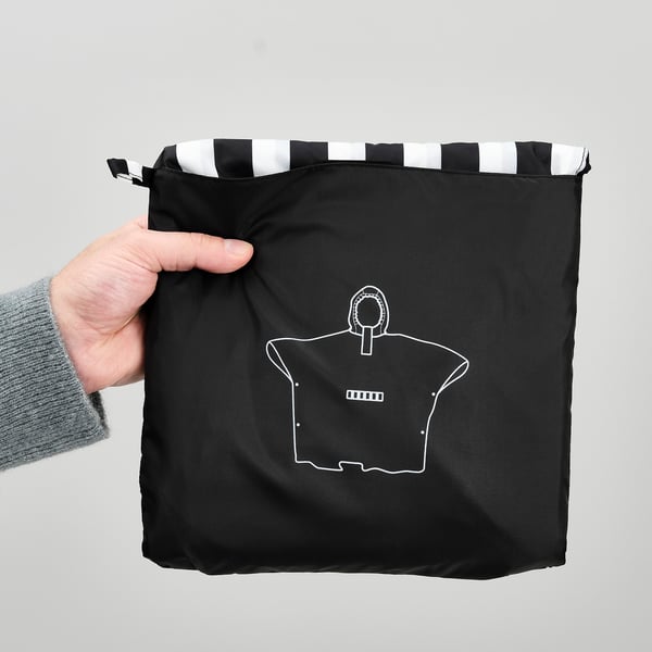 Hand holds black bag with white stripes, featuring white outlines of shirt and battery.
