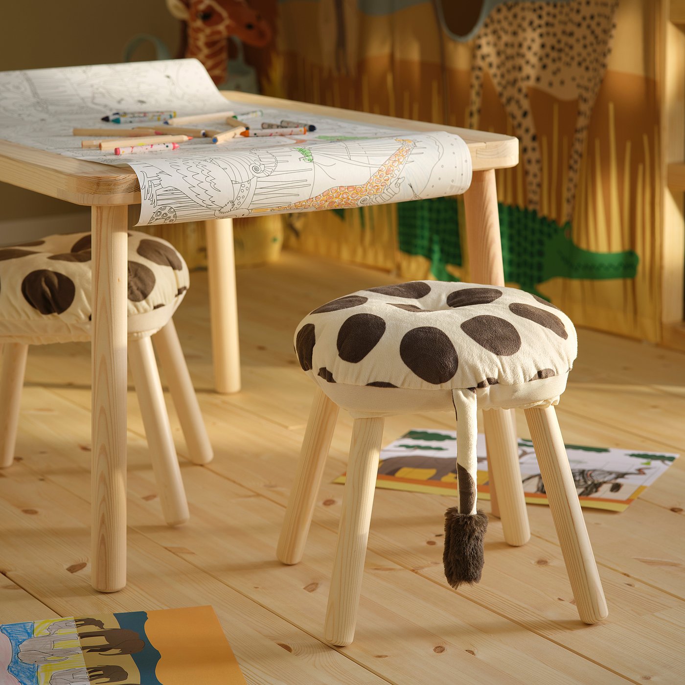 Childs room with giraffe stools, colouring table, toys; playful & inviting.