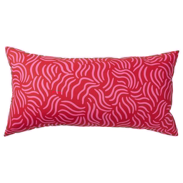 A red rectangular SANDMOTT cushion with pink abstract patterns. It a scandinavian design, made with 100% cotton and mixed fibre filling.