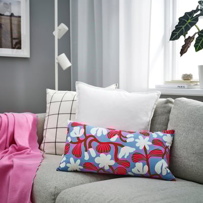 Red & blue floral pillow on grey couch, SANDMOTT collection, modern living room.