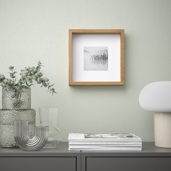 Wooden frame with nature photo & decor on sideboard