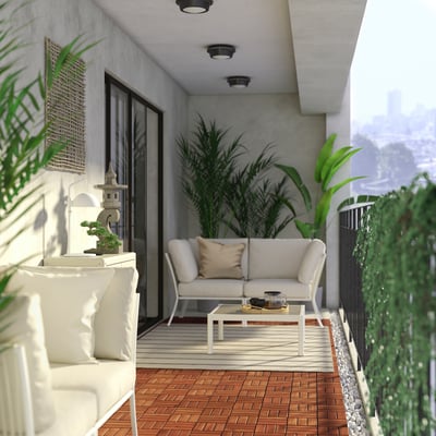 Modern balcony with a white SEGERÖN sofa, wooden floor, plants, and a city view.