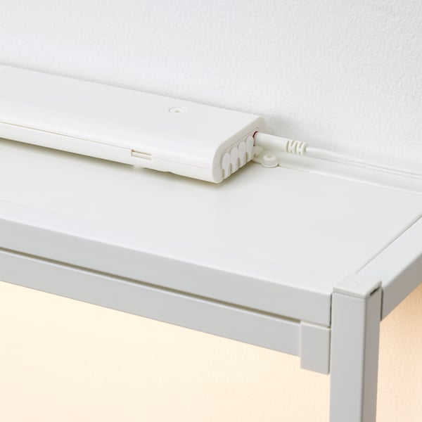 White wall-mounted box with a cord, part of the SILVERGLANS smart lighting system, enabling dimmable control.