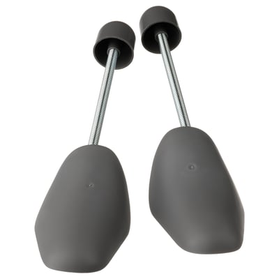 Two grey shoe shapers with flexible metal connectors, designed to maintain shoe shape.