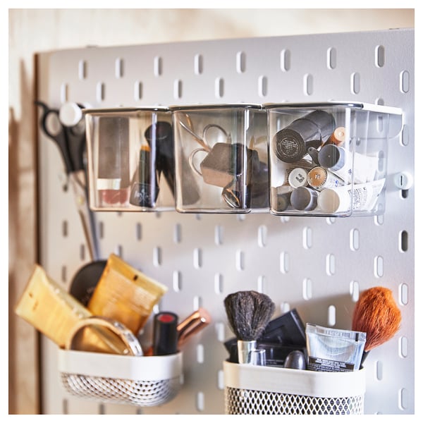 SKÅDIS organiser: clear plastic boxes on white pegboard, holding makeup items.