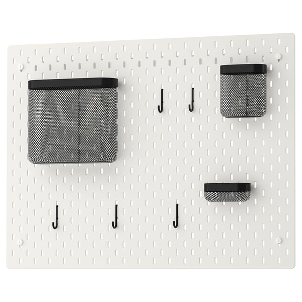 SKÅDIS white pegboard with black mesh bins and hooks for wall organization.