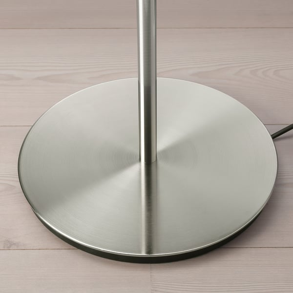 Metal floor lamp on wood floor, modern.
