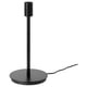 SKAFTET lamp base, black. Sleek, vertical design with circular base, plastic ring, and metallic details. Modern minimalist style for versatile use.