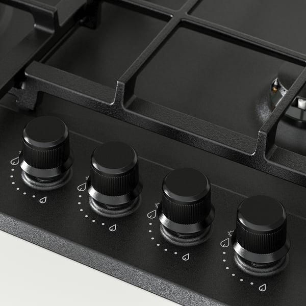 Black gas cooktop with four knobs, sleek design, sturdy supports, electronic ignition.