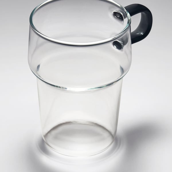 Clear glass mug with sturdy handle; sleek, modern design; transparent and robust.