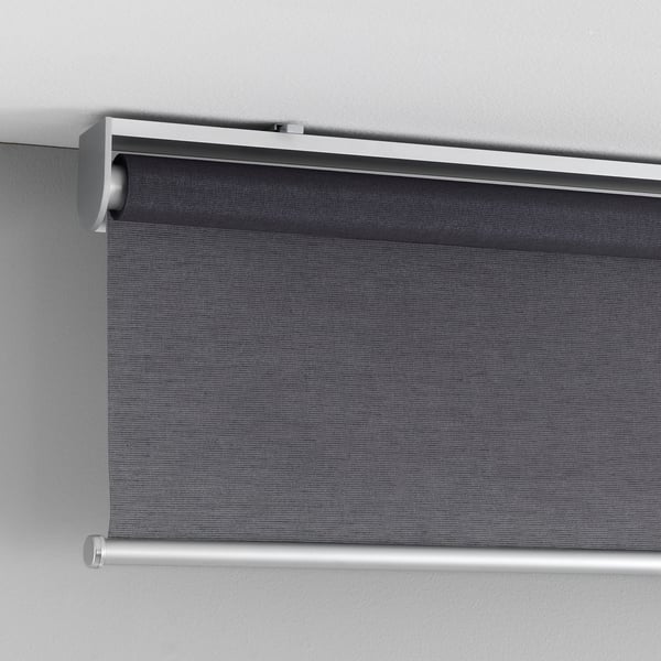 A cordless roller blind, partially lowered, with a sleek design, fixed to a wall. It softly philtres light and safely blocks cords.