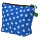 Blue toiletry bag with white polka dots, black zip, green handle, square shape for storage.