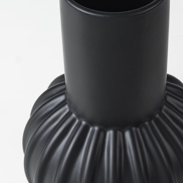 Black vase with ribbed base.