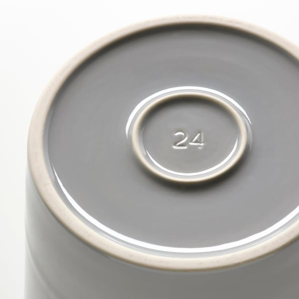 Closeup of a modern plant pots base, featuring a raised, embossed 24 in clean lines, showcasing its durable stoneware craftsmanship.