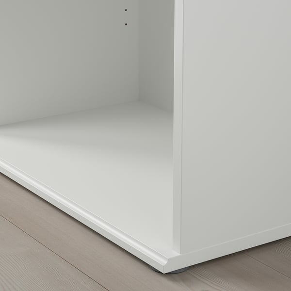 Modern white cabinet with smooth surface and angled base. Clean, minimalist design.
