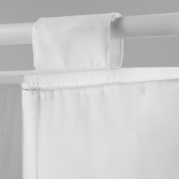 Close-up of white fabric storage pocket with stitching, attached to a white rod using hook and loop fastener.