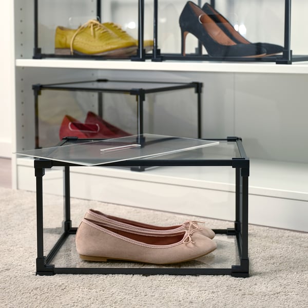 Shoe storage rack with glass tops, displaying shoes neatly and allowing stacking for space efficiency.