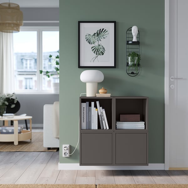 SKUGGRÖNA, green plant stand with shelves, white lamp, framed plant picture, near white door.