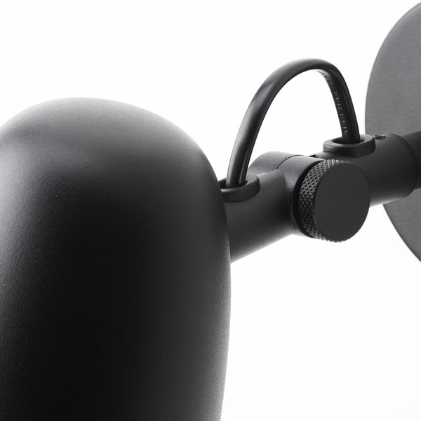 Black adjustable lamp with textured metal finish, showing robust design and flexible arm.