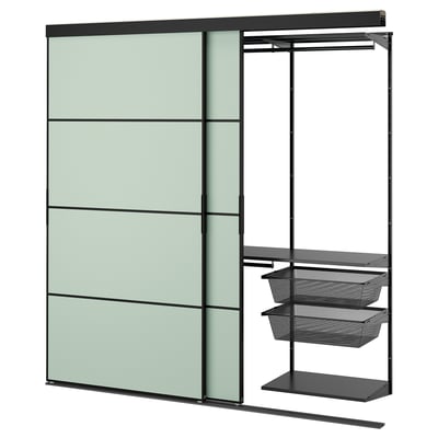 SKYTTA wall unit: green panels, black metal, sliding door, mesh shelves.