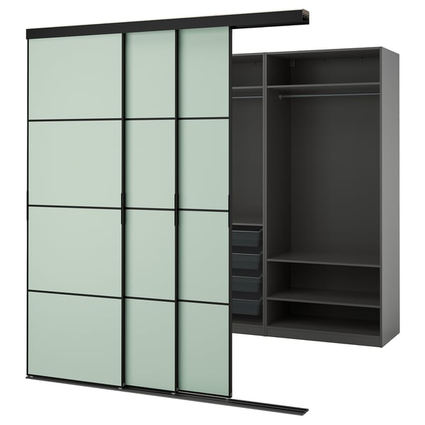 A SKYTTA wardrobe in light green with black interiors and multiple compartments. It sliding glass doors and a sleek, modern design.