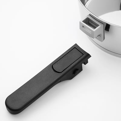 Black plastic cookware handle on white background. Shows handles ergonomic grip and attachment slot.