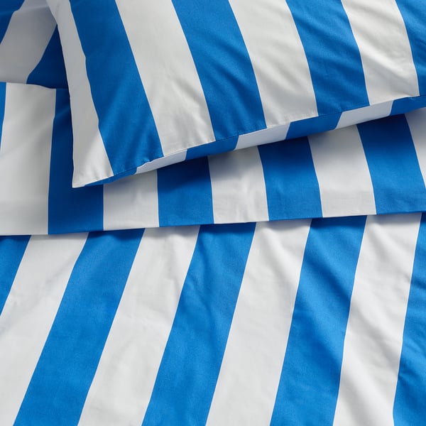 Close-up of crisp, blue and white striped duvet cover, showcasing tight weave and smooth material.
