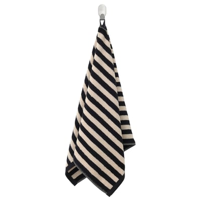 A hanging black and white striped towel, made of cotton, neatly folded with diagonal stripes.