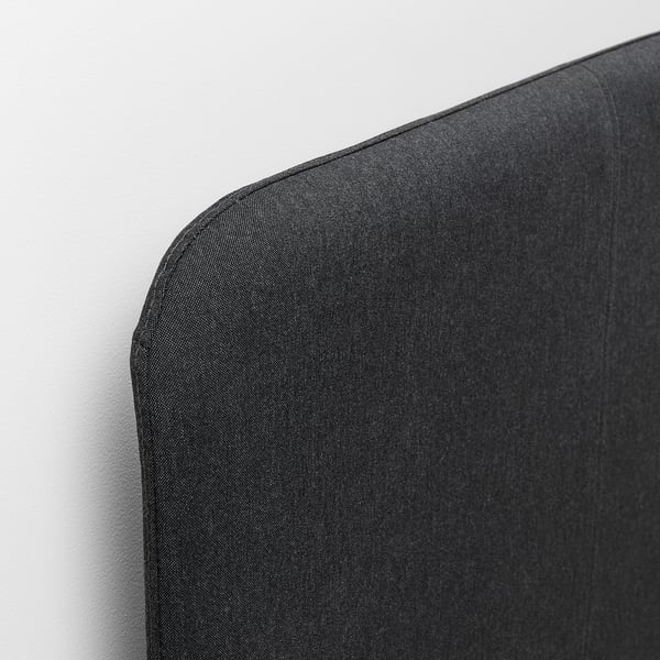 Close-up of grey SLATTUM headboard, showing soft, padded fabric with neat stitching.
