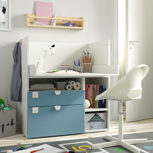 Child’s white desk with blue drawers, storage, and a lamp. Practical for study and play.