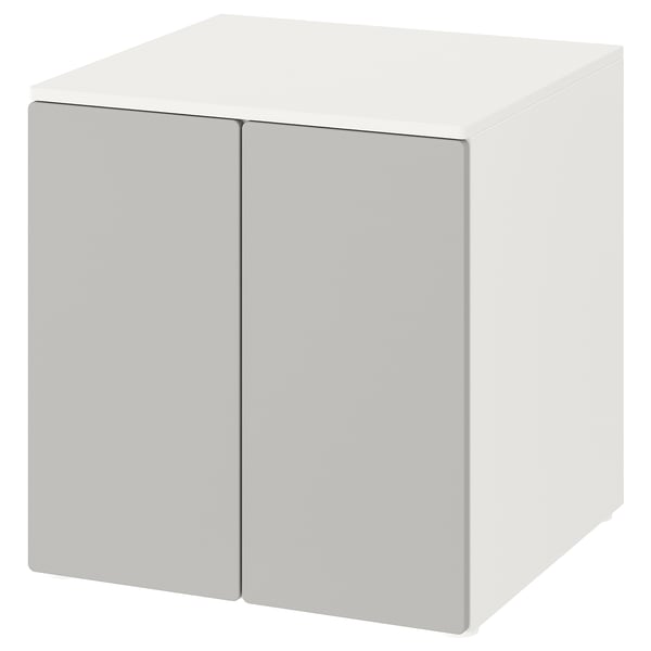 A white, cube-shaped storage cabinet with two doors, named SMÅSTAD, suitable for childrens rooms.