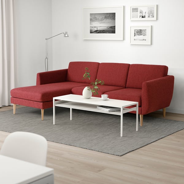 Cosy living room with red SMEDSTORP sofa, white coffee table, and minimalist decor.