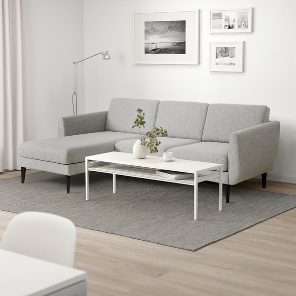 Grey SMEDSTORP sofa with retro style, soft foam cushions, and cone legs in minimalist living room.