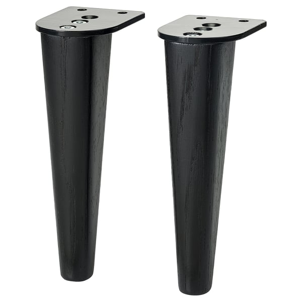 Two black SMEDSTORP furniture legs, tapered design, solid oak, sleek, modern, with metal fittings.