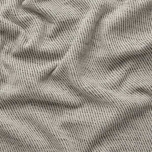 A close-up of a textured, grayish-white woven fabric with a soft, durable feel, likely from a sofa cover.