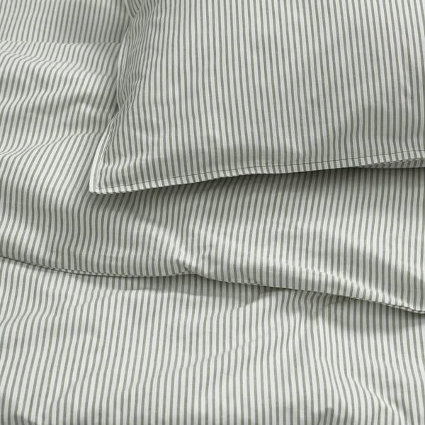 Close-up of neatly folded striped bedding, showcasing high-quality cotton fabric with precise stripes and clean stitching.
