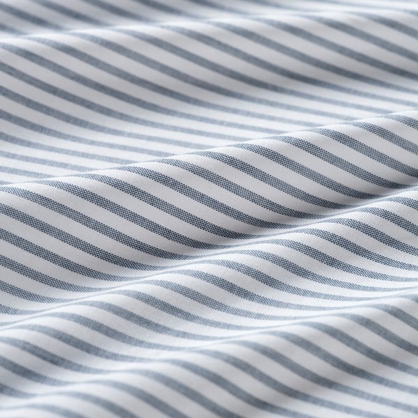 Close-up of recycled cotton fabric, striped light and dark blue, showing texture and quality.