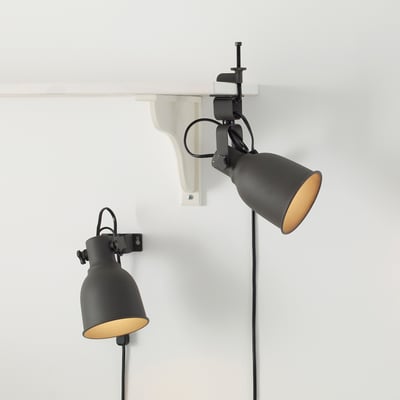 Two black dimmable clip-on lamps attached to a white shelf, providing warm-white led light.