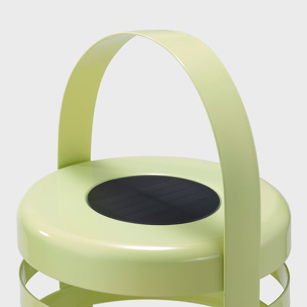 Light green minimalist chair with a black circular seat, well-crafted and modern design.