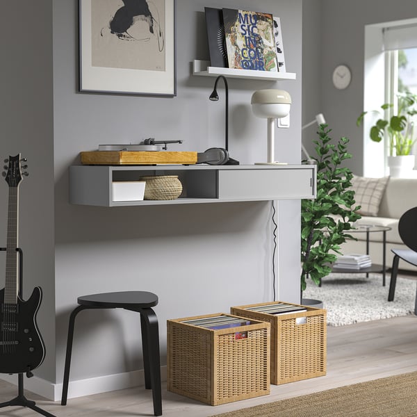 Wall-mounted media shelf, gray, open/closed storage, hides cables.