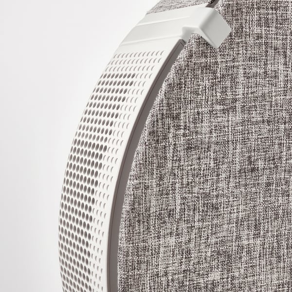 Close-up of a modern air purifier with textured grey fabric and perforated white front, showcasing sleek design and quality materials.