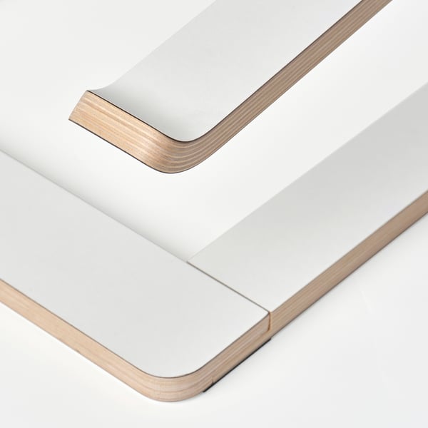 Modern laptop stand made of sleek, layered wood, angled for ergonomic use.