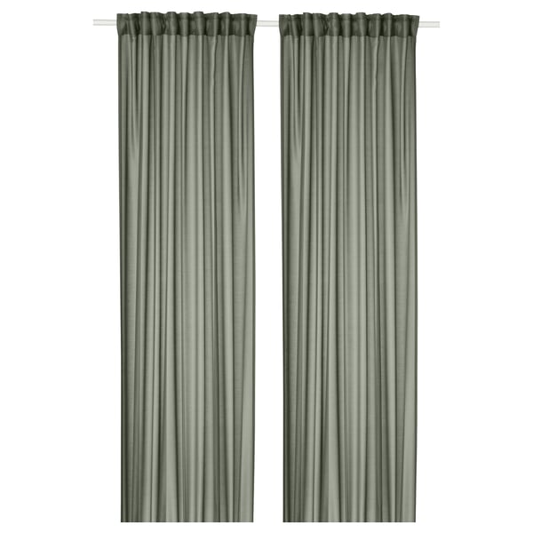 Two green STENFRÖ sheer curtains hang straight, offering a sense of calm. Made from recycled polyester, they diffuse sunlight, adding privacy.