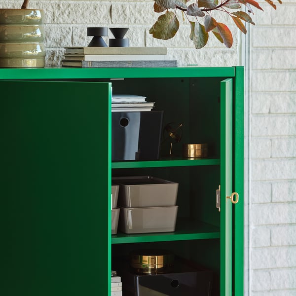 Green STOCKHOLM 2025 cabinet with 2 shelves, secure doors, brass lock.