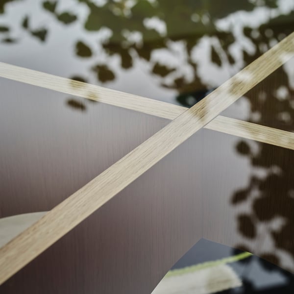 A close-up of a sleek, modern tables wooden frame, showcasing its smooth finish and craftsmanship.