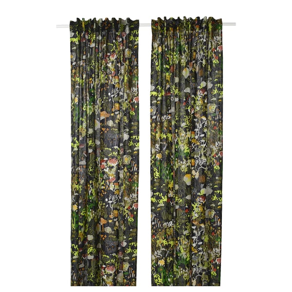 Two dark green curtains with colourful forest patterns hang side by side, adding a whimsical touch to any room.