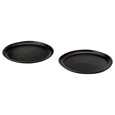 Two black round dishes with a textured, speckled finish are placed side by side.
