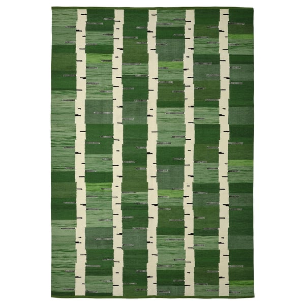 A green handwoven wool rug with a birch tree pattern, reversible, from the stockholm collection.