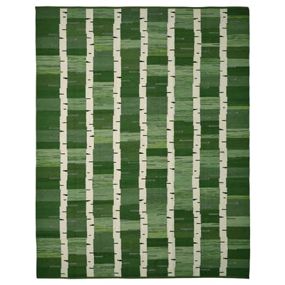 A green handwoven reversible wool rug with a birch tree pattern, part of the stockholm collection.
