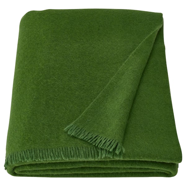 Green ikea STOCKHOLM 2025 throw, rectangular, soft wool/merino blend, fringe edges.